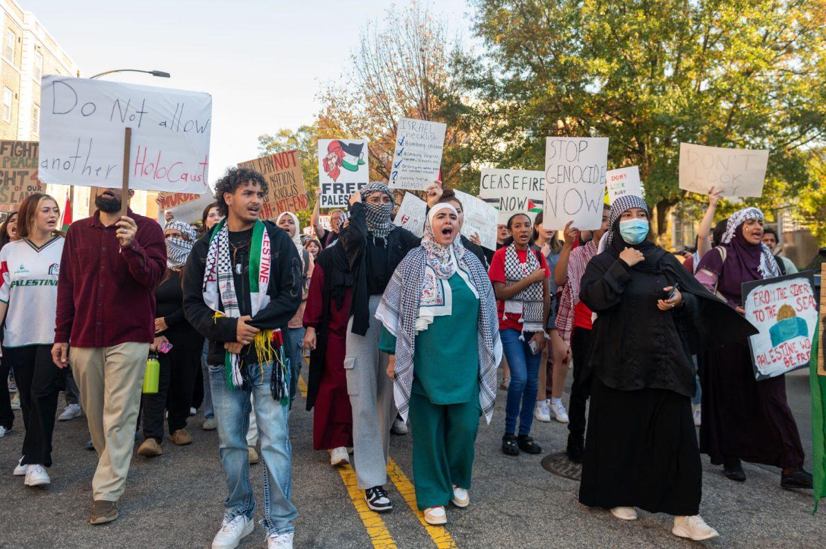 NC State students march down Cates Avenue for the 'Shut it Down! For Palestine' protest Thursday, Nov. 9, 2023. Students started marching at D.H. Hill Library.