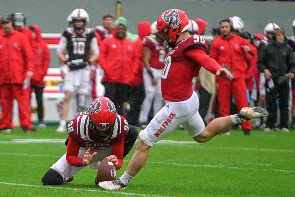 Redshirt sophomore placekicker Caden Noonkester holds the ball for redshirt junior kicker Collin Smith to kick the ball during the spring game at Carter-Finley Stadium on Saturday,&#160;April 8, 2023. The Red team beat the White team 41-10.