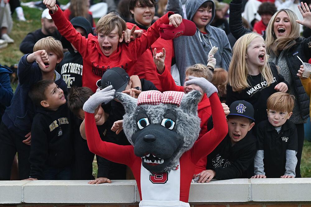 Ms. Wuf poses with young fans of NC State and Wake Forest during the game against the Demon Deacons in Allegacy Federal Credit Union Stadium on Saturday, Nov. 11, 2023. The Wolfpack beat the Demon Deacons 26-6.