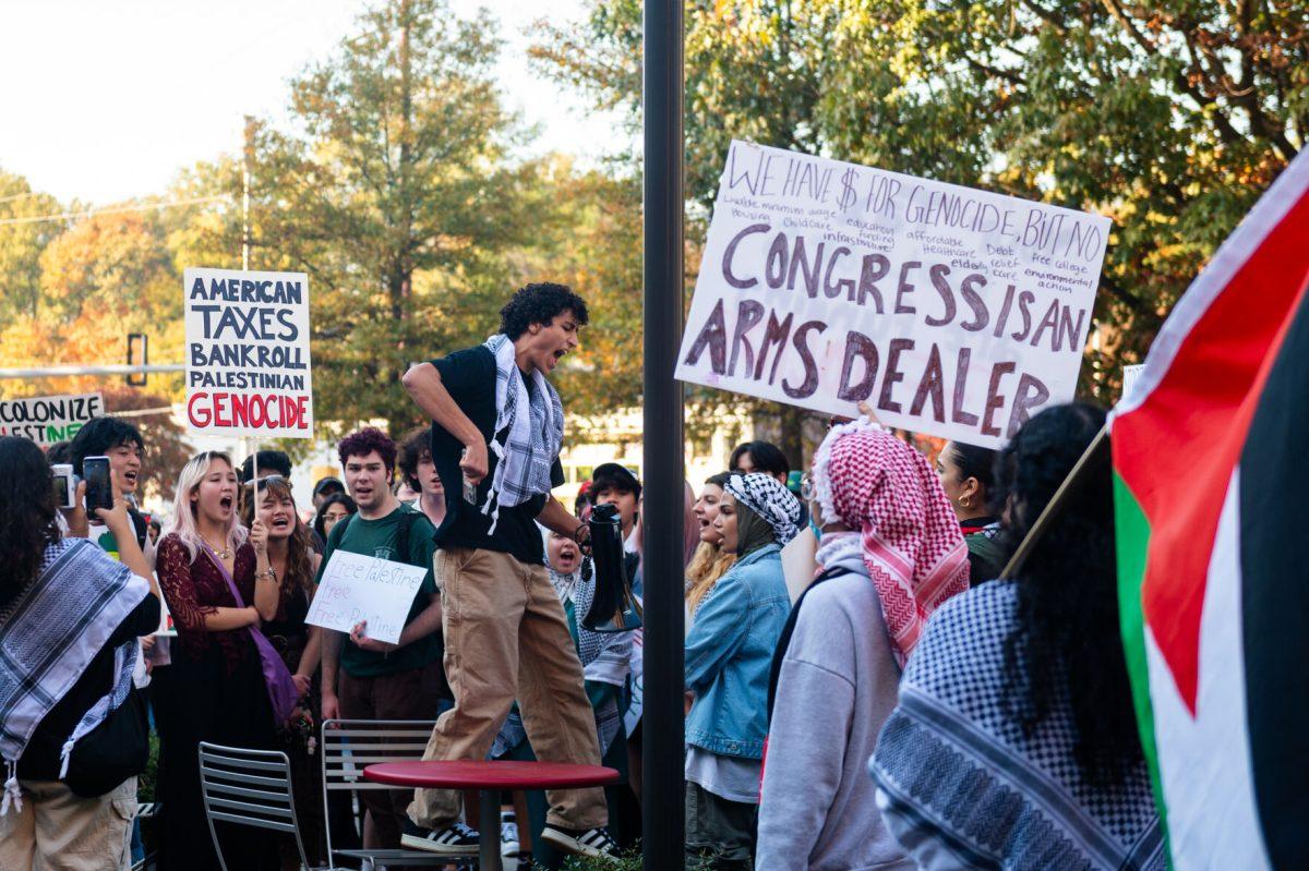 Jamal Mohamad, a fourth-year studying business, leads a chant during the 'Shut it Down! For Palestine' protest on Thursday, Nov. 9, 2023. Students started marching at D.H. Hill Library.