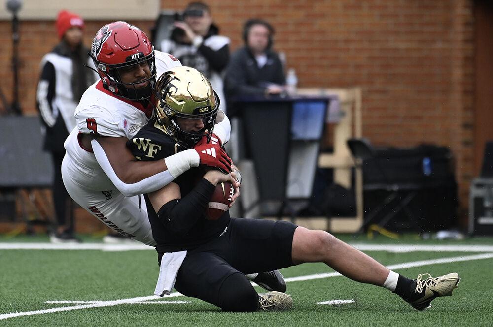 Senior defensive end Savion Jackson sacks the quarterback during the game against the Wake Forest Demon Deacons in Allegacy Federal Credit Union Stadium on Saturday, Nov. 11, 2023. Jackson recorded four tackles and two sacks. The Wolfpack beat the Demon Deacons 26-6.