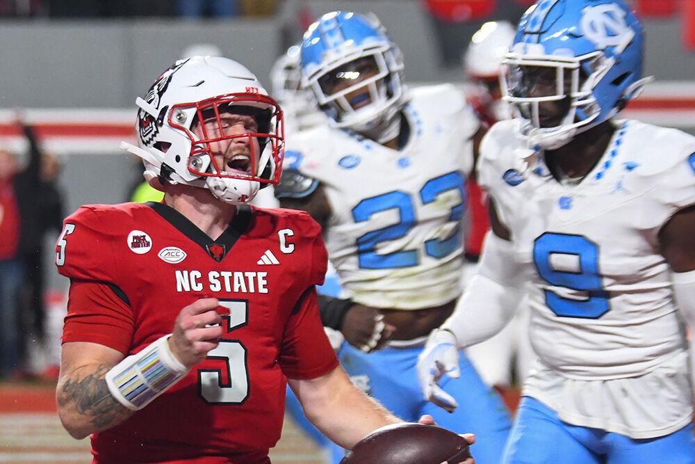 Graduate quarterback Brennan Armstrong cheers during the game against UNC-Chapel Hill at Carter-Finley Stadium on Saturday, Nov. 25, 2023. Armstrong made three touchdowns for the Wolfpack. NC State won the game against UNC-Chapel Hill 39-20.