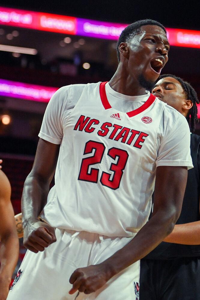 Junior forward Mohamed Diarra celebrates making a contested layup during the game versus the Mount Olive Trojans in PNC Arena on Wednesday, Nov. 1, 2023. Diarra scored ten points and had seven rebounds against Mount Olive. The Wolfpack beat the Trojans 89-79.