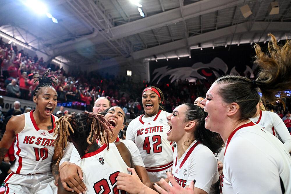 The women's basketball team celebrates after the game against UConn in Reynolds Coliseum on Sunday, Nov. 12, 2023. NC State defeated UConn 92-81.