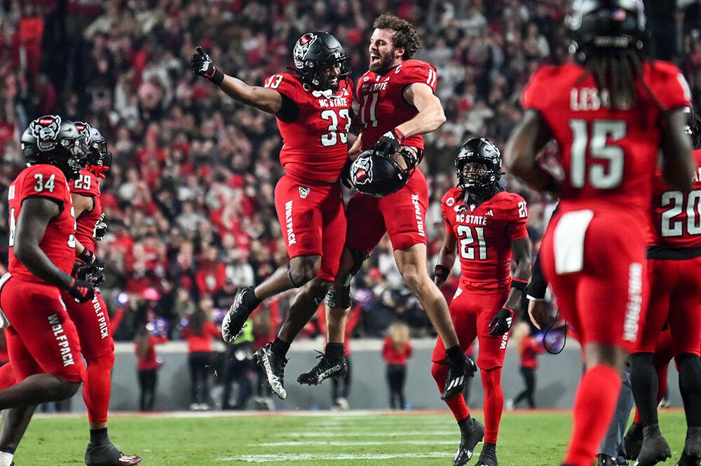 Red shirt sophomore running back Jordan Poole and senior linebacker Payton Wilson chest-bump after Poole scored a touchdown during the game against Miami at Carter-Finley Stadium on Saturday, Nov. 4, 2023. This was Poole's first career touchdown. NC State beat Miami 20-6.