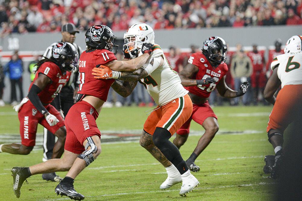 Graduate linebacker Payton Wilson holds back his opponent during the football game against Miami at Carter-Finley Stadium on Saturday, Nov. 11, 2023. Wilson completed 16 total tackles. NC State beat Miami 20-6.