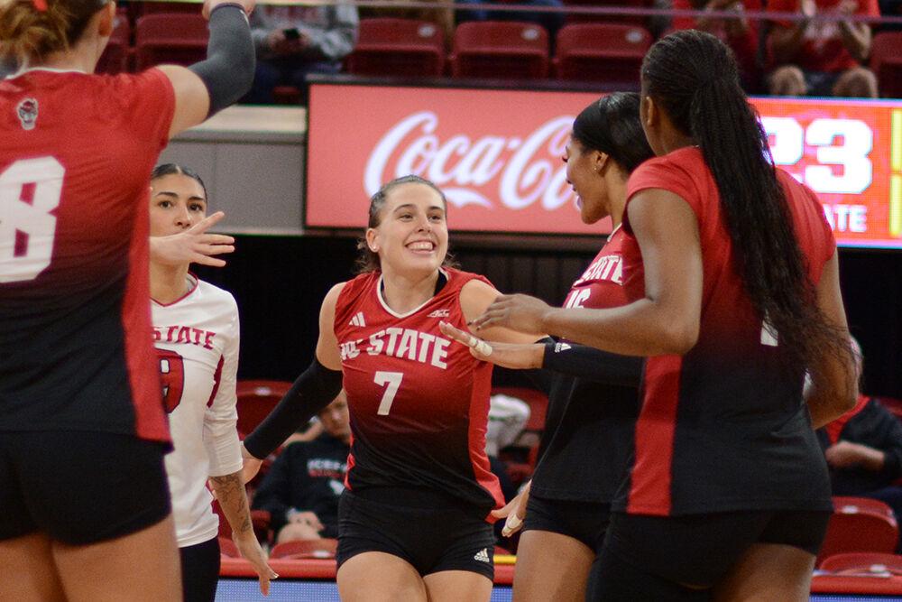 Sophomore outside hitter Ava Brizard smiles as she celebrates a point with her teammates during the match against Syracuse in Reynolds Coliseum on Sunday, Nov. 5, 2023. Brizard led the Wolfpack offense with 13 kills. NC State defeated the Syracuse 3-0.