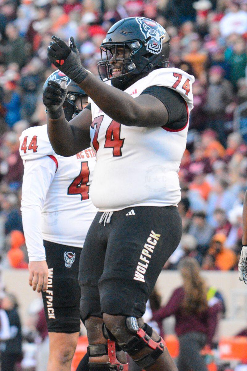 Redshirt junior offensive tackler Anthony Belton celebrates during the game against Virginia Tech at Lane Stadium on Saturday, Nov. 18, 2023. Wolfpack beat the Hokies 35-28.