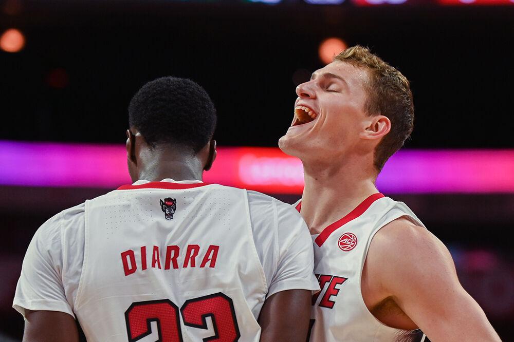 Junior forward Ben Middlebrooks chest bumps junior forward Mohamed Diarra during the game versus the Mount Olive Trojans in PNC Arena on Wednesday, Nov. 1, 2023. Middlebrooks and Diarra both had seven rebounds against Mount Olive. The Wolfpack beat the Trojans 89-79.