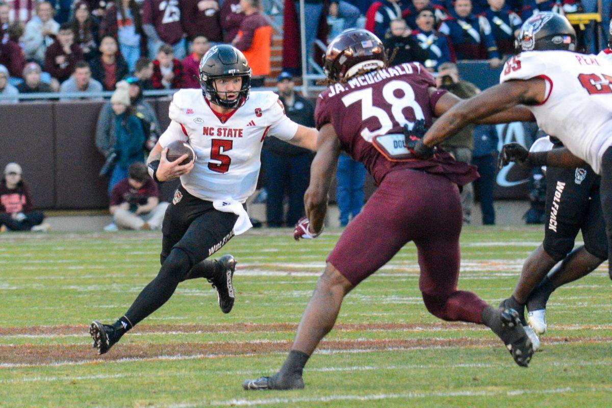 Graduate quarterback Brennan Armstrong runs down the field during the game against Virginia Tech at Lane Stadium on Saturday, Nov. 18, 2023. Wolfpack beat the Hokies 35-28.