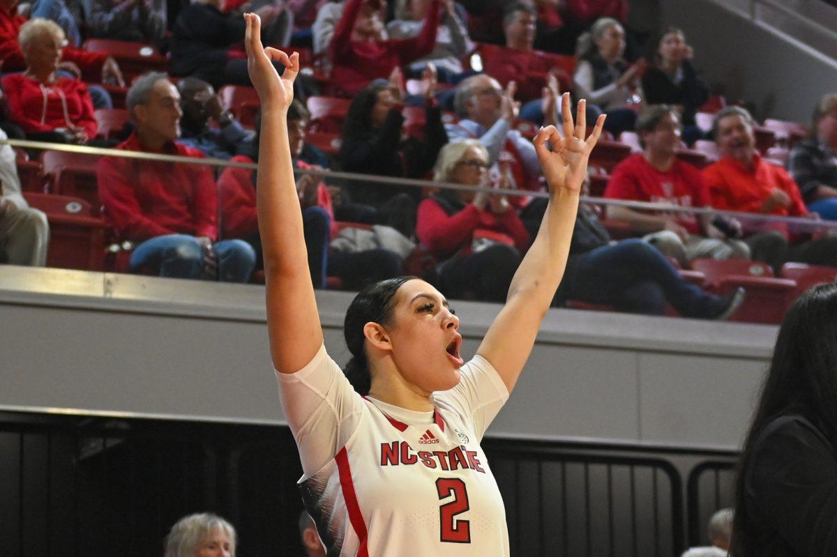 Graduate forward Mimi Collins cheers after a 3-pointer was scored in the game against Elon in Reynolds Coliseum on Wednesday, Nov. 15, 2023. Collins scored 18 points for the Wolfpack and made six rebounds. NC State won the game against Elon 90-35.