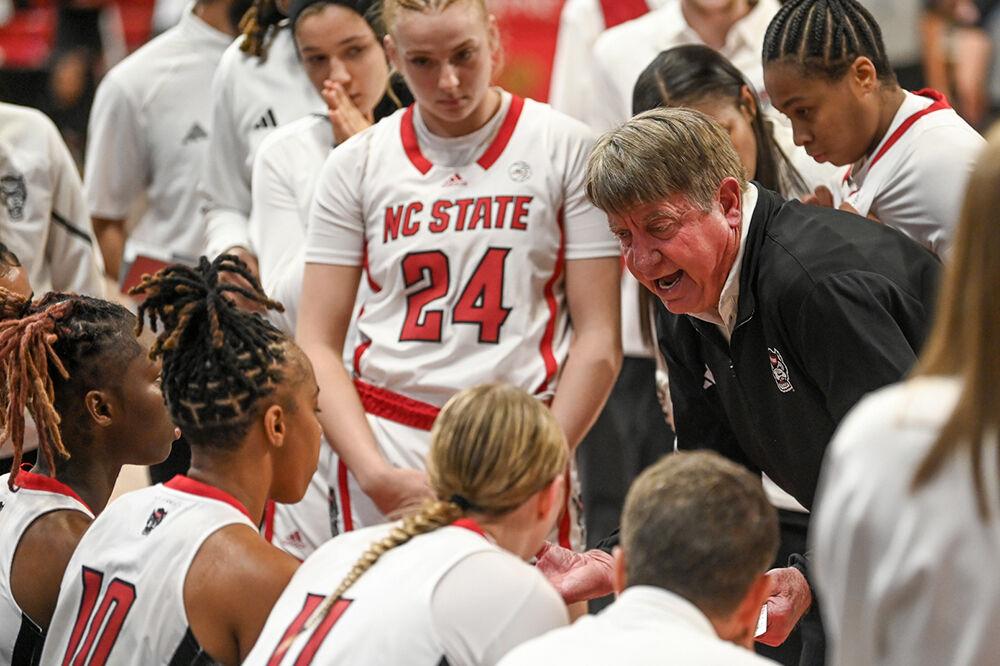 Head Coach Wes Moore discusses the final minutes of the game with his team while playing against the UConn Huskies in Reynolds Coliseum on Sunday, Nov. 12, 2023. The Wolfpack beat the Huskies 92-81.