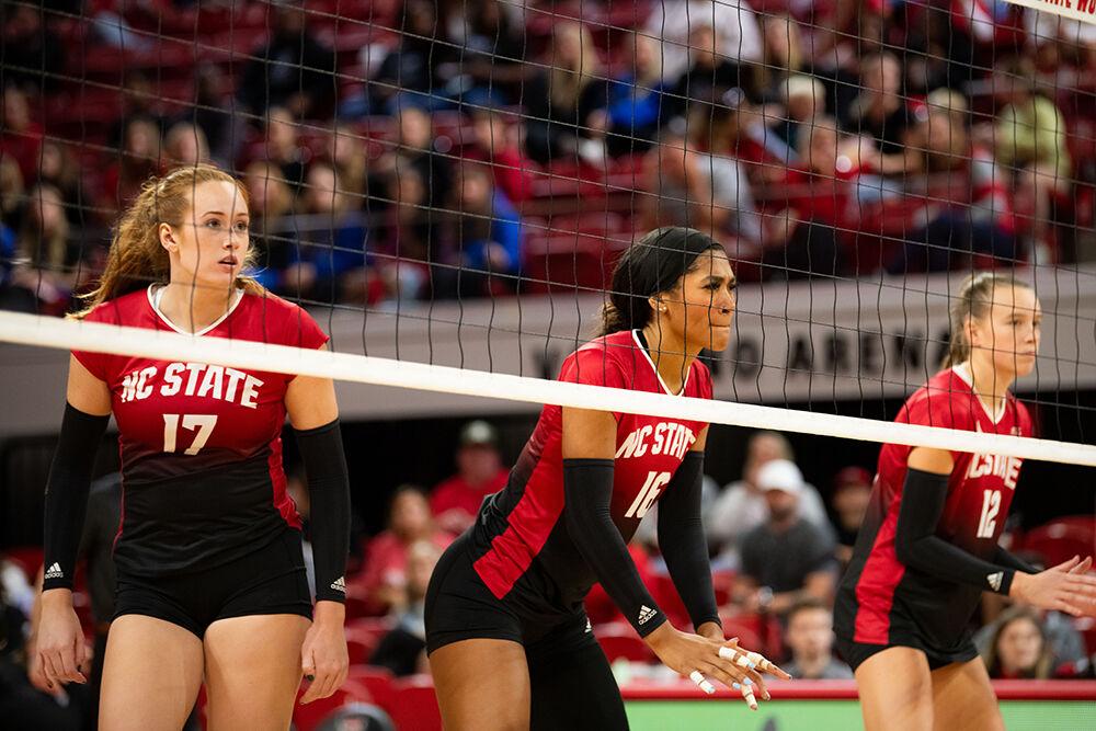 Junior opposite hitter Amanda Rice, junior middle blocker Jada Allen, and sophomore outside hitter Courtney Bryant prepare for an oncoming serve during the match against UVA in Reynolds Coliseum on Sunday, Oct. 22, 2023. NC State beat UVA 3-0.