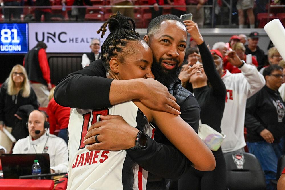 Junior guard Aziaha James hugs her former coach EJ Newman after the Wolfpack win over the UConn Huskies in Reynolds Coliseum on Sunday, Nov. 12, 2023. James scored 18 points against UConn. The Wolfpack beat the Huskies 92-81.