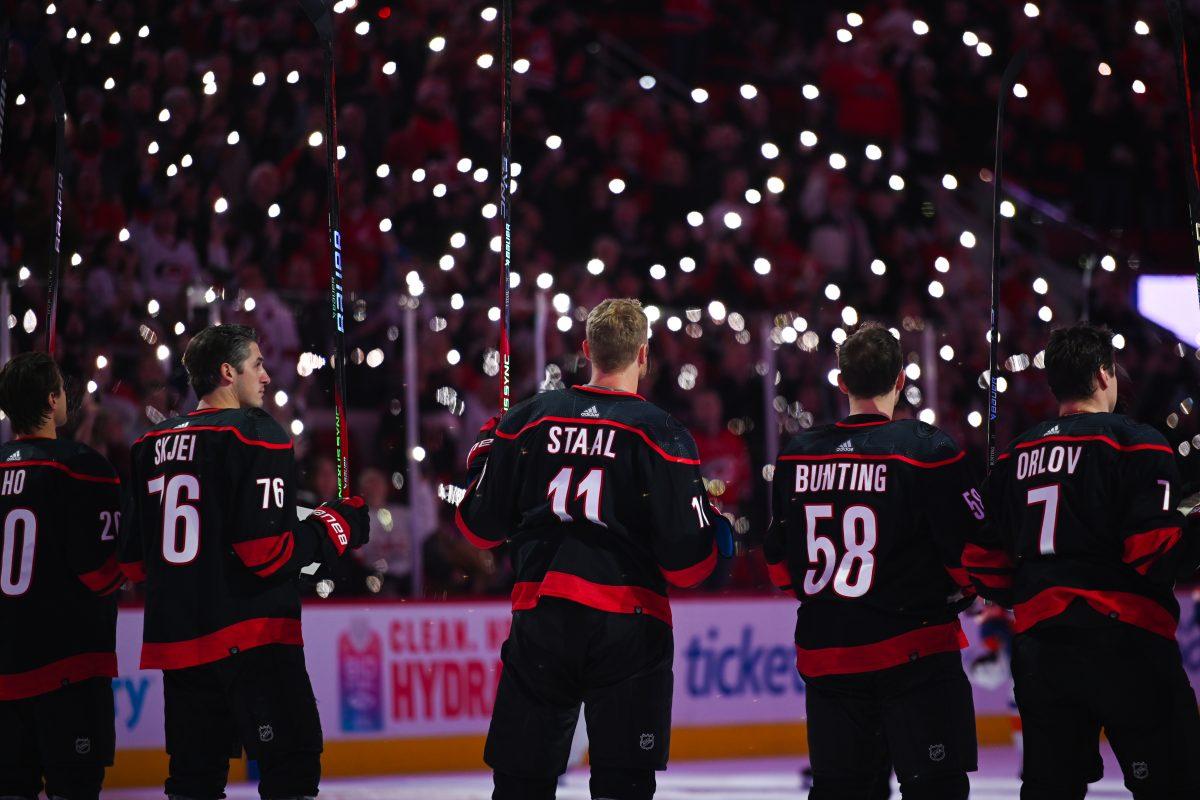 The Carolina Hurricanes stand in honor of the NHL's Hockey Fights Cancer before the game against the New York Islanders in PNC Arena on Thursday, Nov. 30, 2023. Hockey Fights Cancer helps to raise funds an awareness to help fight cancer. The Islanders beat the Hurricanes 5-4 in overtime.