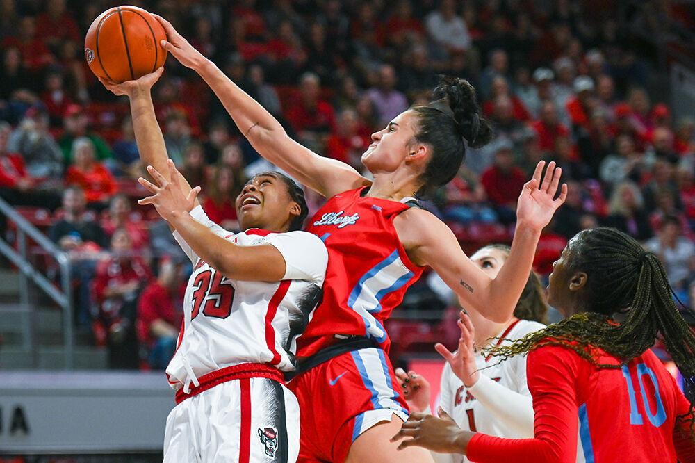 Freshman guard Zoe Brooks jumps to shoot the ball during the game against Liberty at Reynolds Coliseum on Sunday, Dec. 10, 2023. Brooks scored 14 points for NC State. NC State beat Liberty 80-67.
