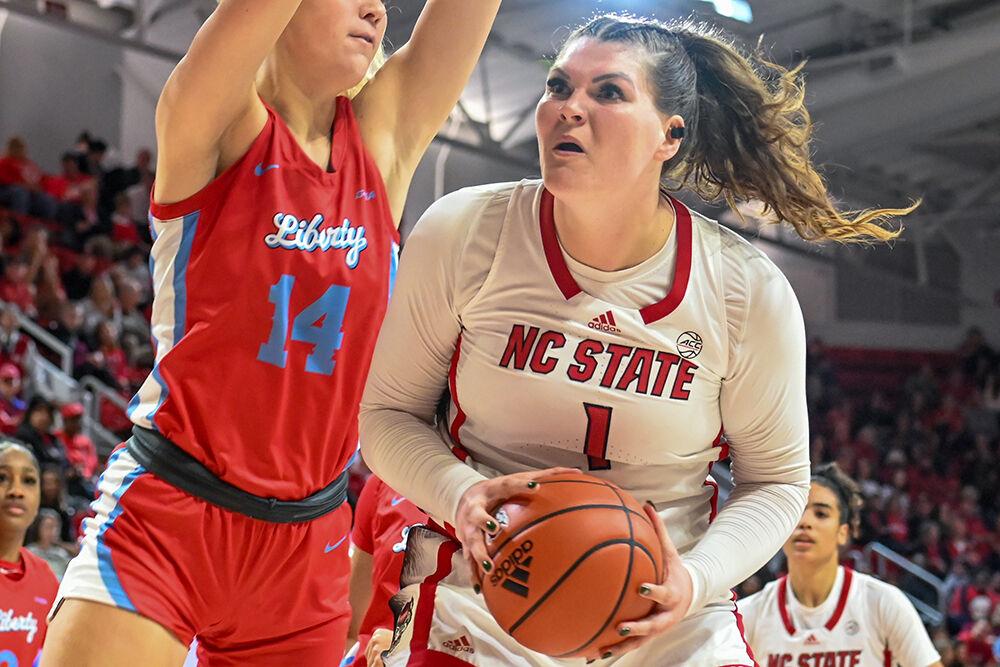 Graduate center River Baldwin posts up during the game versus Liberty at Reynolds Coliseum on Sunday, Dec. 10, 2023. NC State won the game 80-67.