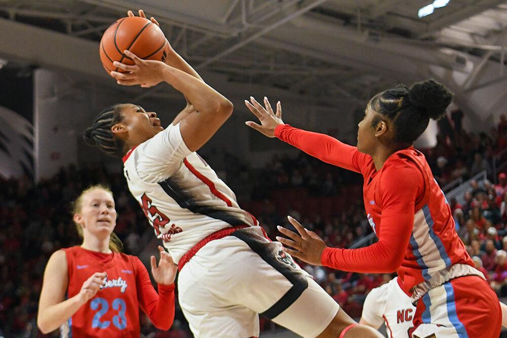 Freshman guard Zoe Brooks leans back to make a shot in the game against Liberty in Reynolds Coliseum on Sunday, Dec. 10, 2023. Brooks is the second player in program history to secure a triple-double and the first to do so since 2001. The Wolfpack won the game 80-67.