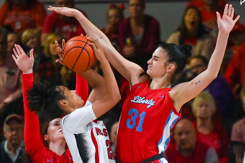 Senior guard Madison Hayes attempts to shoot the ball during the game against Liberty at Reynolds Coliseum on Sunday, Dec. 10, 2023. Hayes scored 15 points for NC State. NC State beat Liberty 80-67.