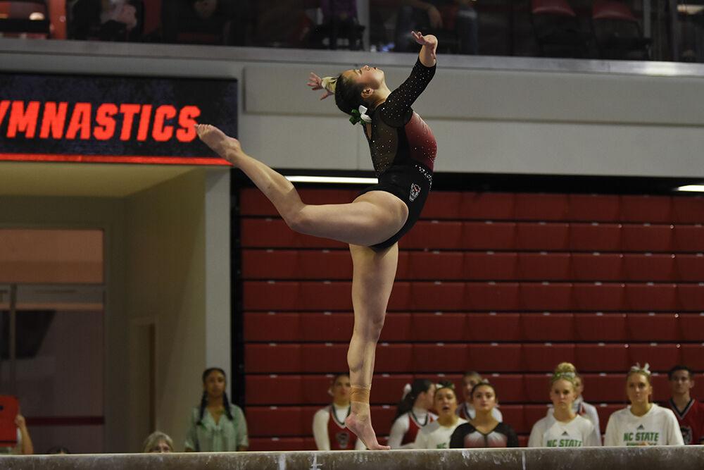 Senior Chloe Negrete performs her balance routine in the meet against New Hampshire at Reynolds Coliseum on Friday, Feb. 17, 2023. Negrete scored 9.825 on the vault, 9.850 on the beam, and 9.900 on her floor routine. NC State won the meet against New Hampshire with an overall score of 196.150.