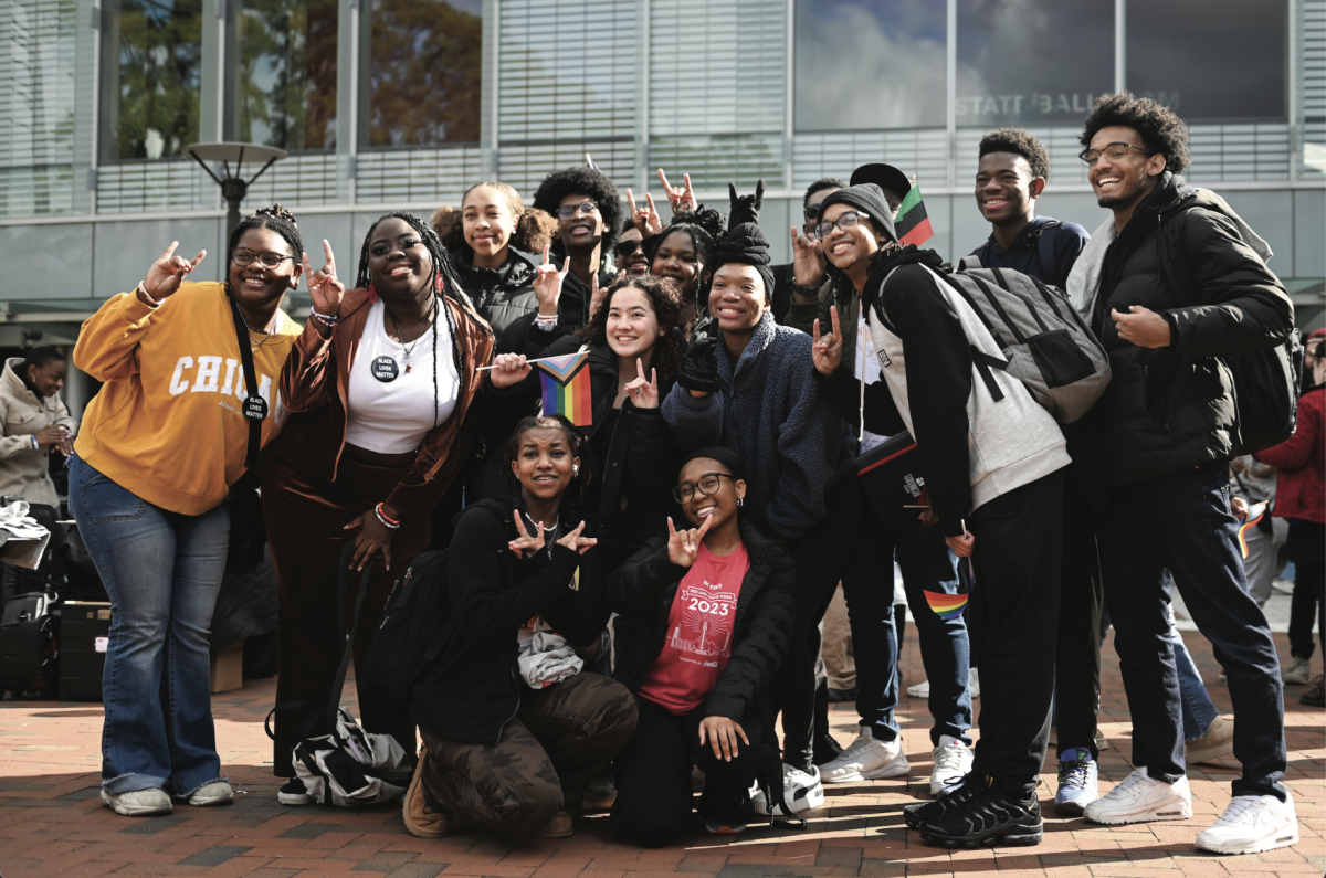 First-year students participating in the walk pose for a photo before the March Like Martin event at Stafford Commons on Friday, Jan. 19, 2024. The student-led march honored Martin Luther King Jr.&#8217;s legacy and promoted activism and the organizing of communities.