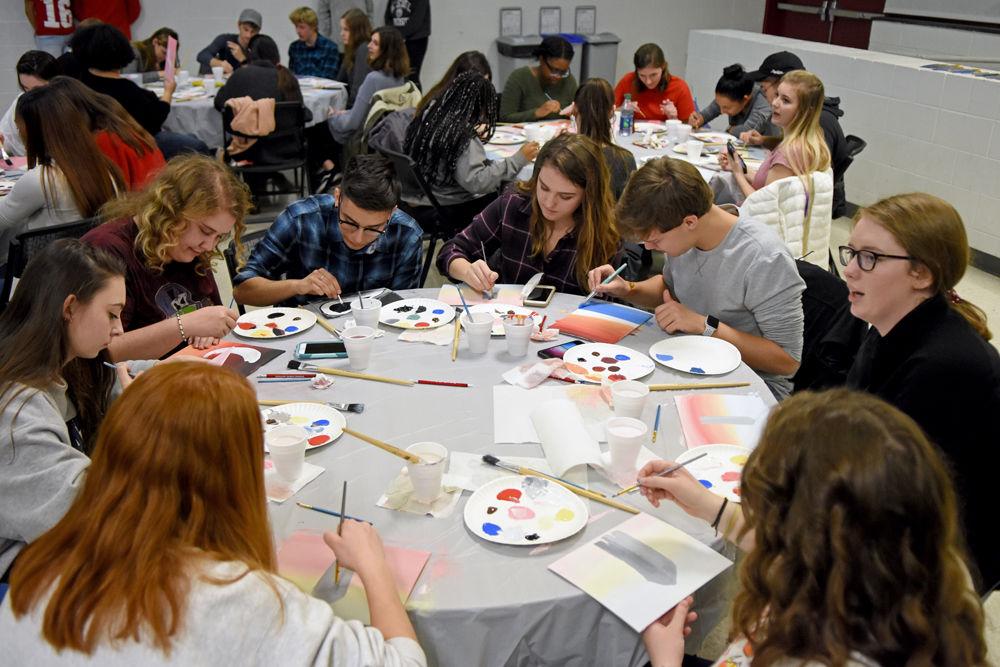 Students paint the Memorial Belltower at the FDOC Paint Party on Monday, Jan. 7 at Witherspoon Student Center.