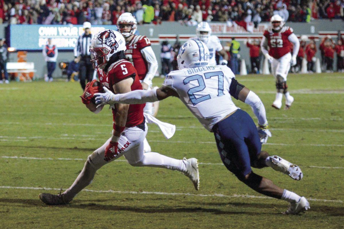In this archive photo taken Nov. 26, 2021, wide receiver Thayer Thomas runs into the end zone during the game versus UNC-Chapel Hill at Carter-Finley Stadium. Thomas had 11 rushing yards at the end of the game. The NC State Wolfpack beat the UNC-Chapel Hill Tar Heels 34-30.
