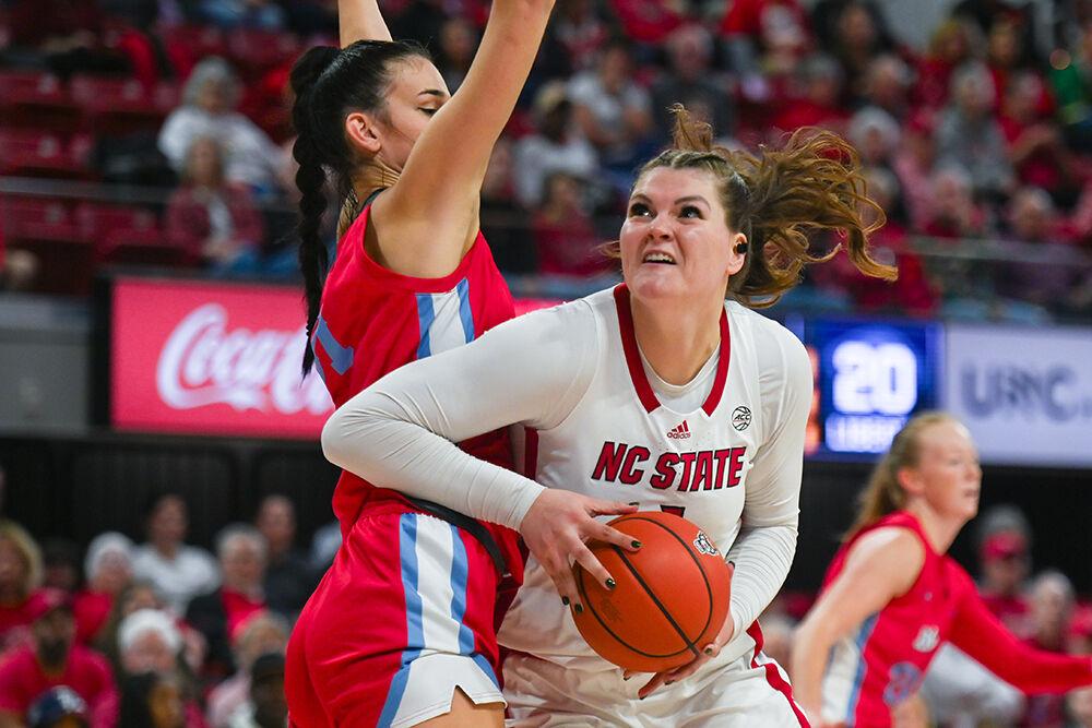 Graduate center River Baldwin evades her opponent during the game against Liberty at Reynolds Coliseum on Sunday, Dec. 10, 2023. Baldwin scored eight points for NC State. NC State beat Liberty 80-67.