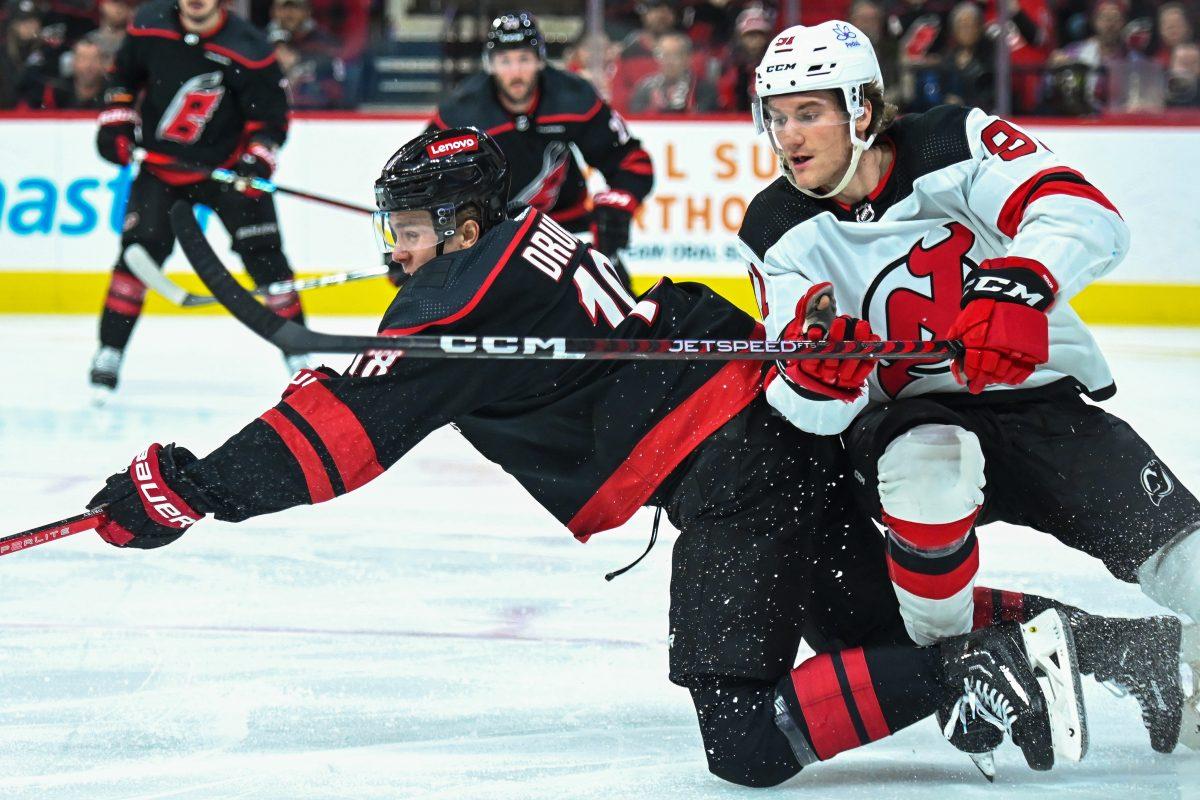 Center Jack Drury lunges for the puck during the Carolina Hurricanes game versus the New Jersey Devils at PNC Arena on Thursday, Jan. 25, 2024. The Hurricanes beat the Devils 3-2.
