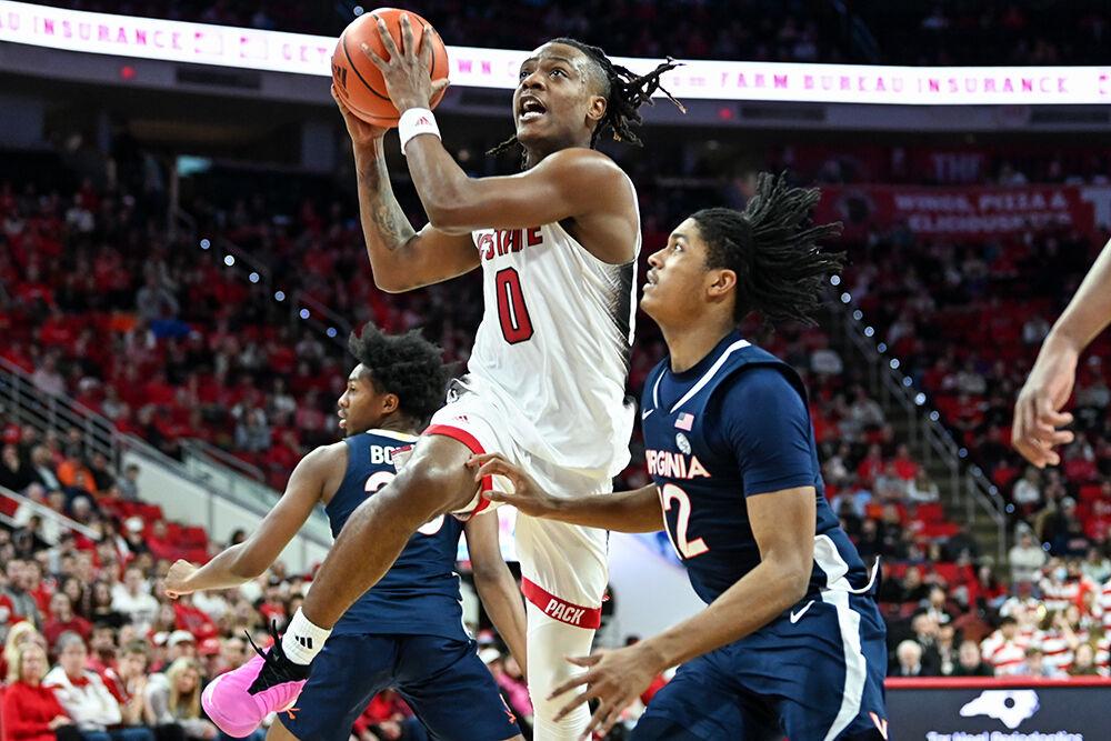 Graduate guard DJ Horne breaks through the defense to shoot a layup during the game against Virginia in PNC Arena on Saturday, Jan. 6, 2024. Horne recorded 14 points, six rebounds, three assists and two steals. NC State beat Virginia 76-60.