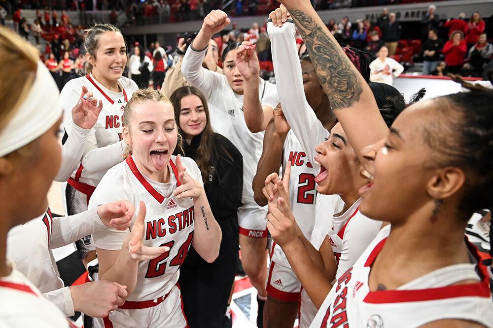 NC State celebrates in the huddle after the game against Duke in Reynolds Coliseum on Sunday, Jan. 21, 2024. NC State beat Duke 72-57.