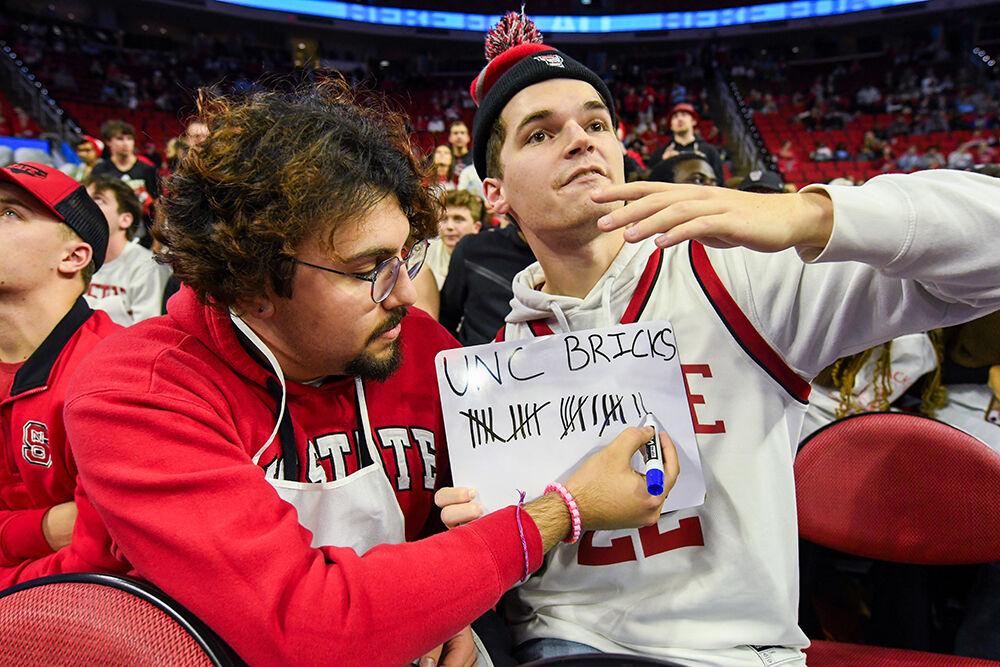 Alec Henderson and Arsalaan Khan, third-years studying computer science, count the amount of missed shots by the UNC-Chapel Hill team during warm-ups in PNC Arena on Wednesday, Jan. 10, 2024. The Tar Heels beat the Wolfpack 67-54.