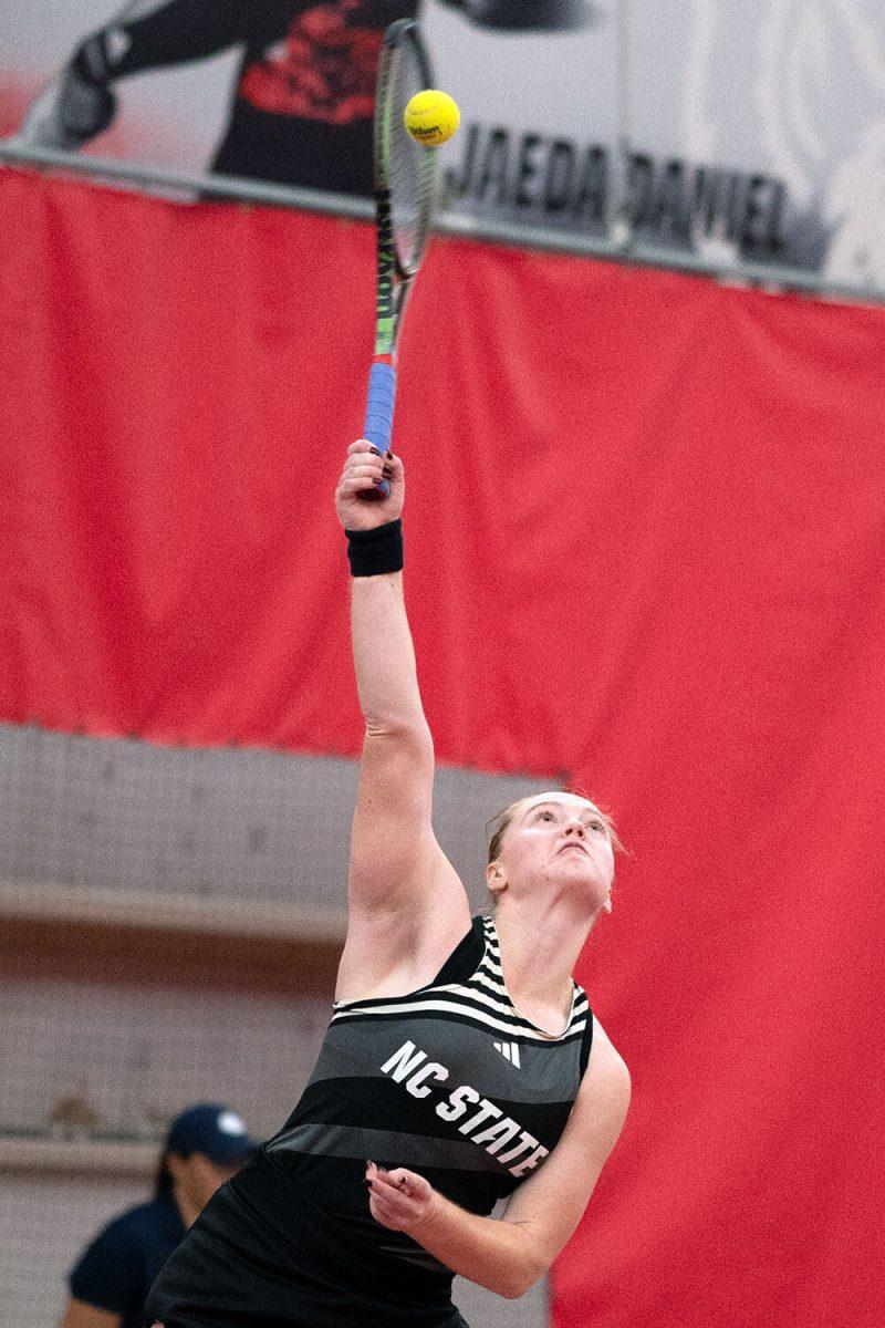 Senior Sophie Abrams serves during the match against Clemson at J.W. Isenhour Tennis Center on Sunday, Jan. 28, 2024. Abrams won both her singles and doubles matches. NC State beat Clemson 4-0.