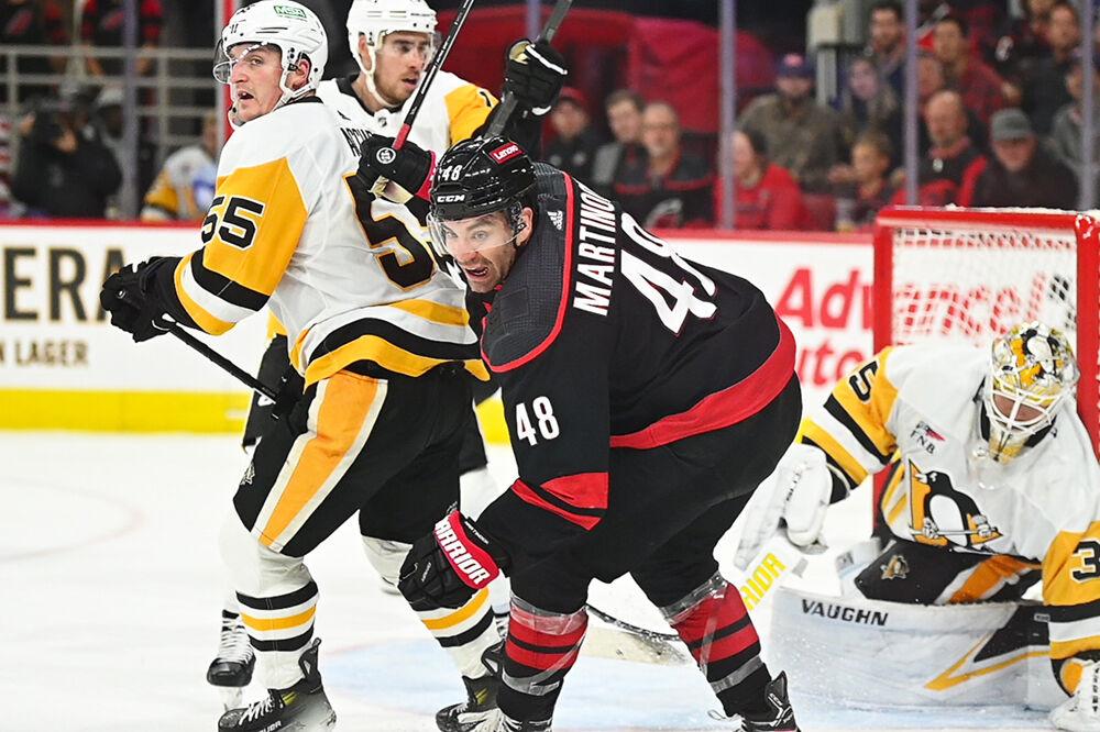 Left wing Jordan Martinook fights for the puck during the Carolina Hurricanes game versus the Pittsburgh Penguins at PNC Arena on Saturday, Nov. 18, 2023. The Hurricanes beat the Penguins 4-2.