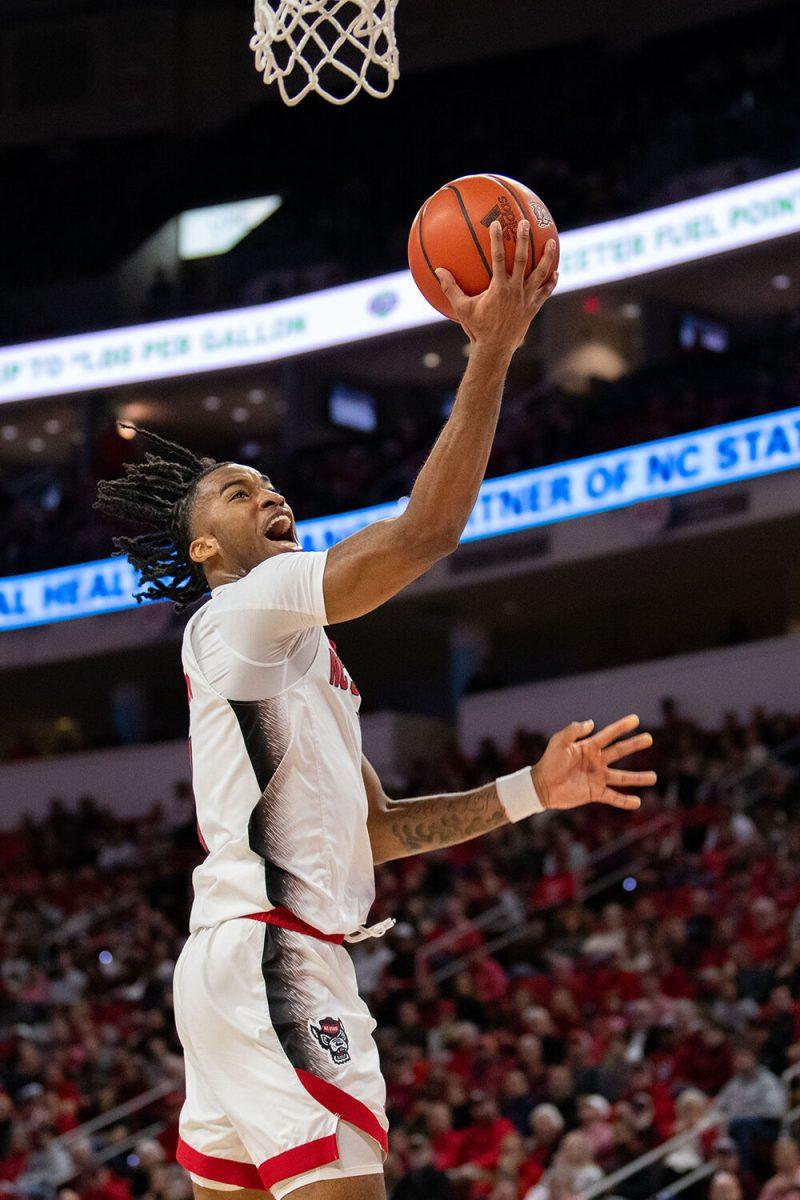 Junior guard Jayden Taylor reaches to score a basket during the game against Virginia Tech in PNC Arena on Saturday, Jan. 20, 2024. Taylor had five rebounds, two steals and scored 15 points during the game. NC State lost to Virginia Tech 84-78.