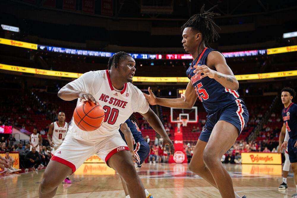 Graduate forward DJ Burns faces his defender with the ball during the game against UT Martin in PNC Arena on Tuesday, Dec. 12, 2023. Burns had 12 rebounds, five assists and scored ten points during the game. The Wolfpack beat the Skyhawks 81-67.