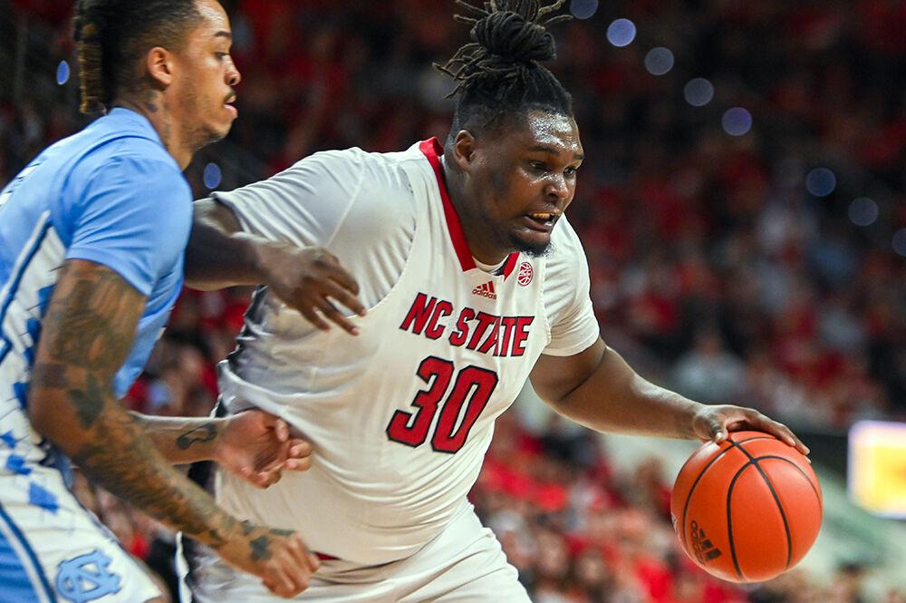 Graduate forward DJ Burns attempts to break past UNC-Chapel Hill graduate center Armando Bacot in PNC Arena on Wednesday, Jan. 10, 2024. Burns scored 11 points against UNC-Chapel Hill. The Tar Heels beat the Wolfpack 67-54.