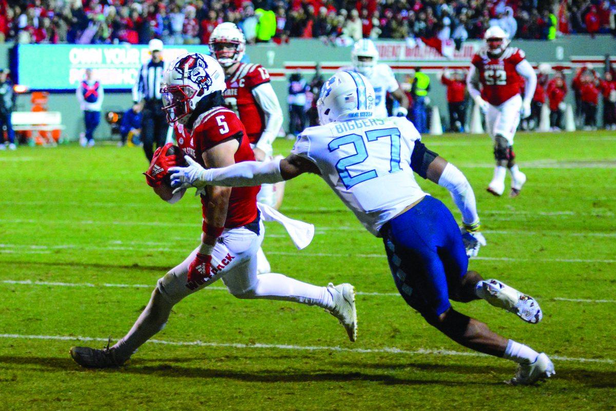 In this archive photo taken Nov. 26, 2021, wide receiver Thayer Thomas runs into the end zone during the game versus UNC-Chapel Hill at Carter-Finley Stadium. Thomas had 11 rushing yards at the end of the game. The NC State Wolfpack beat the UNC-Chapel Hill Tar Heels 34-30.