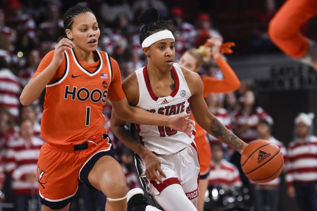 Junior guard Aziaha James dribbles the ball away from her opponent during the game against Virginia at Reynolds Coliseum on Thursday, Jan. 11, 2024. James made two steals and scored 15 points. The Wolfpack beat the Cavaliers 93-66.