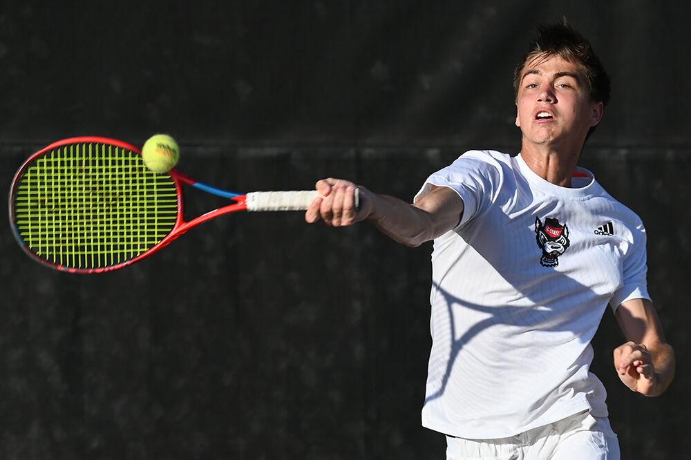 Redshirt sophomore Braden Shick jumps to forehand the ball during the match against Wake Forest at Dail Outdoor Tennis Stadium on Wednesday, April 12, 2023. Shick won both his singles and doubles matches. NC State beat Wake Forest 4-2.