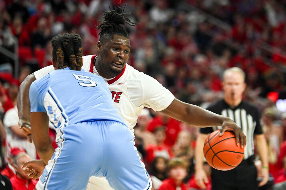 Graduate forward DJ Burns tries to shake off the defensive effort by UNC-Chapel Hill graduate center Armando Bacot in PNC Arena on Wednesday, Jan. 10, 2024. Burns scored 11 points against UNC-Chapel Hill. The Tar Heels beat the Wolfpack 67-54.