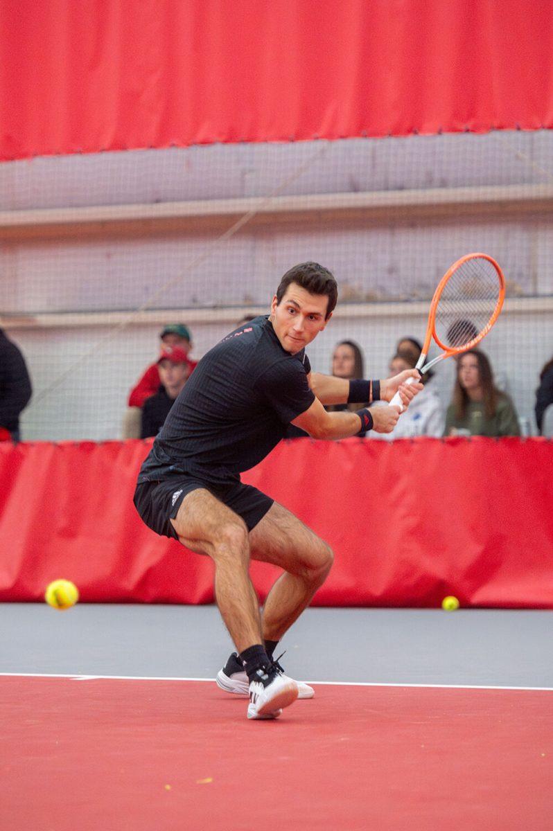 Senior Luca Staeheli backhands the ball during the match against Northwestern at J.W. Isenhour Tennis Center on Monday, Jan. 15, 2024. Staeheli won his singles 7-6 (7-2), 6-4. NC State won 6-1 against Northwestern.