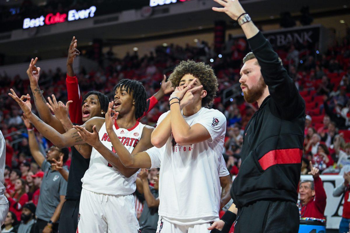 The NC State bench celebrates a made three-pointer by Jayden Taylor during the game against Miami on Tuesday, Jan. 30, 2024. The Wolfpack defeated the Hurricanes 74-68.
