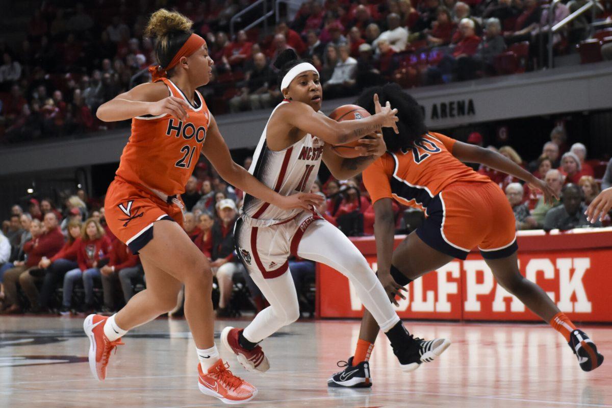 Junior guard Aziaha James protects the ball while running during the game against Virginia at Reynolds Coliseum on Thursday, Jan. 11, 2024. James made two steals and scored 15 points. The Wolfpack beat the Cavaliers 93-66.