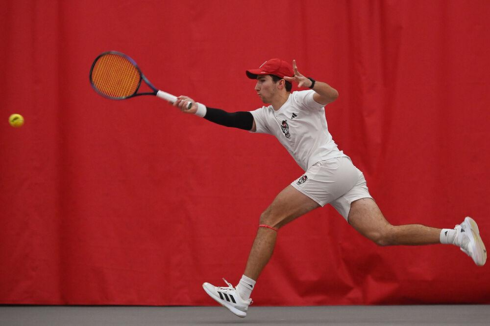 Junior Joseph Wayand swings at the ball during the match against Princeton at J.W. Isenhour Tennis Center on Friday, Jan. 19, 2024. Wayand won both his doubles and singles matches. NC State beat Princeton 7-0.