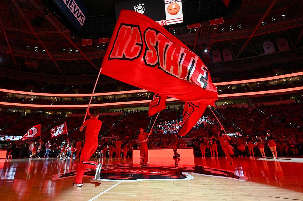 The NC State Cheerleading Team waves NC State flags before the game versus the UNC-Chapel Hill Tar Heels in PNC Arena on Wednesday, Jan. 10, 2024. The Tar Heels beat the Wolfpack 67-54.