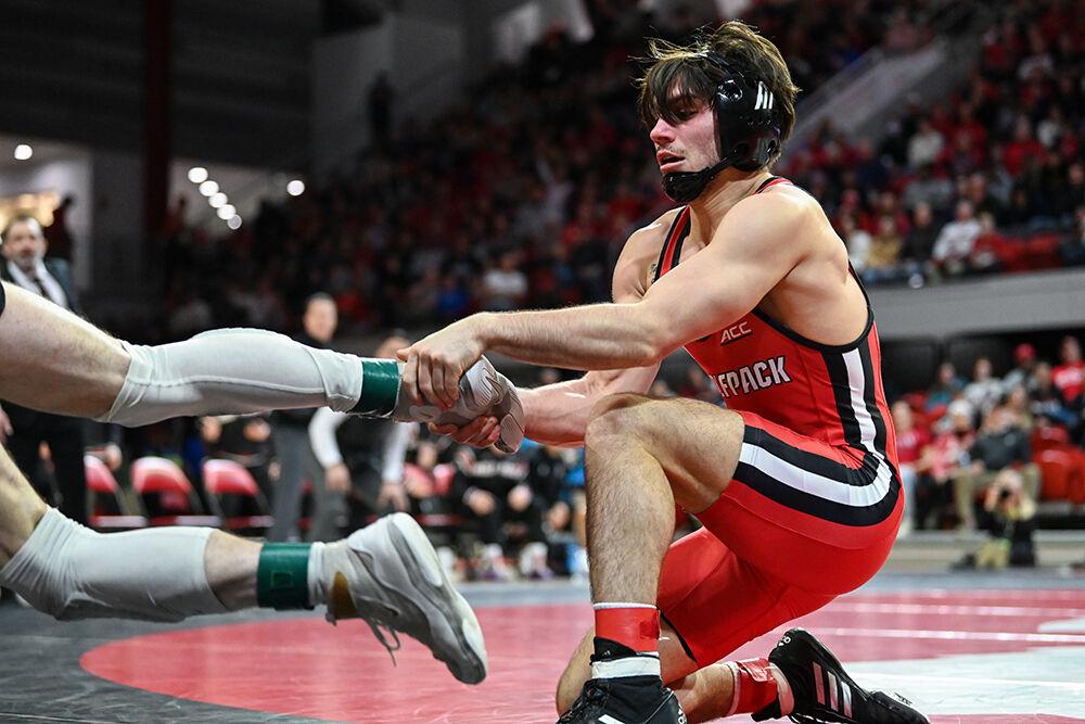 Junior Ryan Jack keeps his opponent inbounds during the duel against Oklahoma State in Reynolds Coliseum on Friday, Jan. 5, 2023. Jack won the 141 bout 6-4. NC State lost to Oklahoma State 22-12.