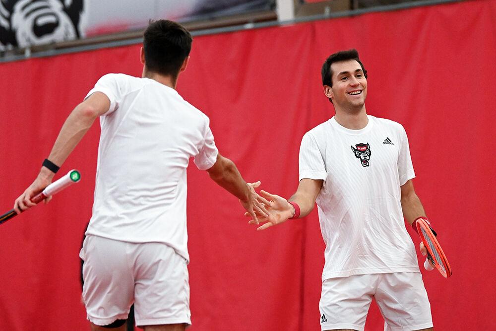Junior Braden Shick and senior Luca Staeheli high-five after scoring a point during the match against Princeton at J.W. Isenhour Tennis Center on Friday, Jan. 19, 2024. Shick and Staeheli won their doubles match 7-5. NC State beat Princeton 7-0.