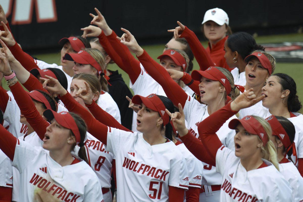 The women's softball team interacts with the crowd after the game against North Dakota State at Dail Softball Stadium on Friday, Feb. 16, 2024. The team yelled "wolf" and the crowd responded with "pack!" NC State beat North Dakota State 6-4.
