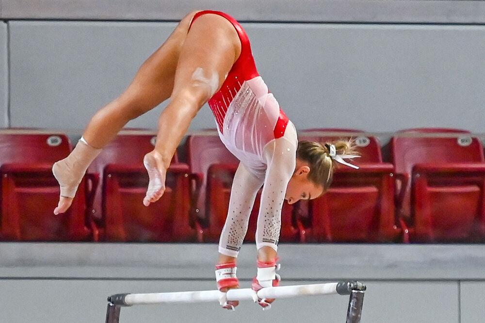 Junior Peyton Childs performs her routine on the uneven bars during the Red and White exhibition meet at Reynolds Coliseum on Sunday, Dec. 17, 2023. The Red team defeated the White team 3-1.